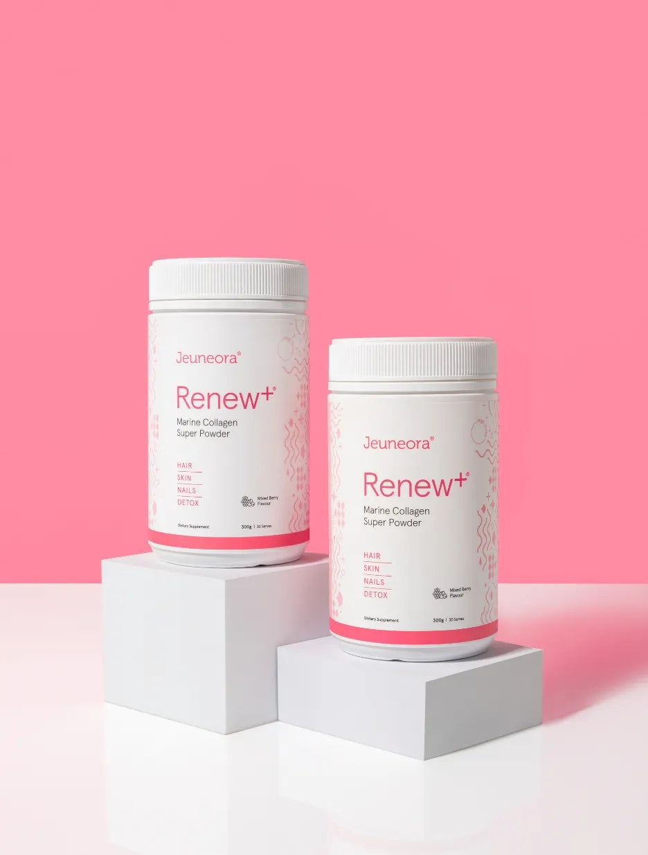 Two Mixed Berry containers of Renew+ Marine Collagen powder on a pink background