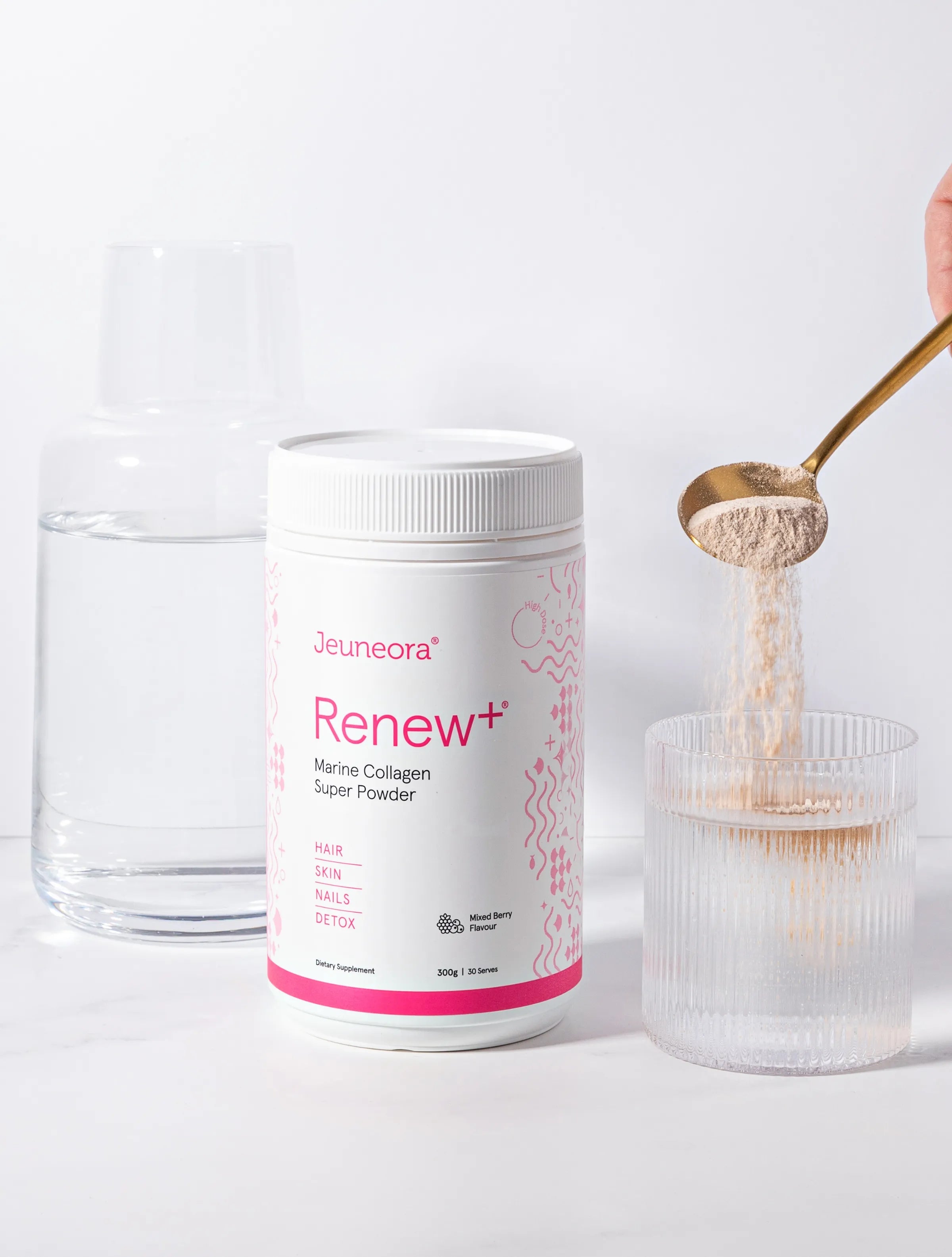 scoop of collagen powder pouring into glass of water