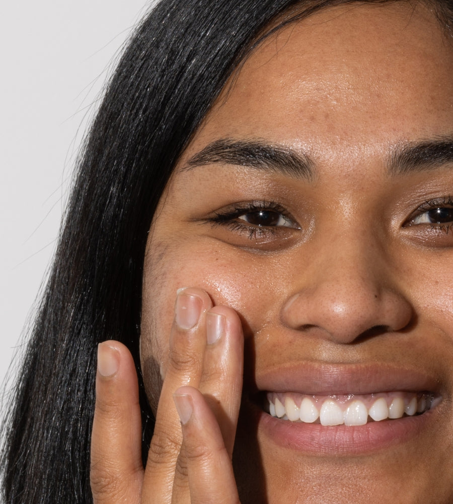 woman applying hyaluronic acid serum to face
