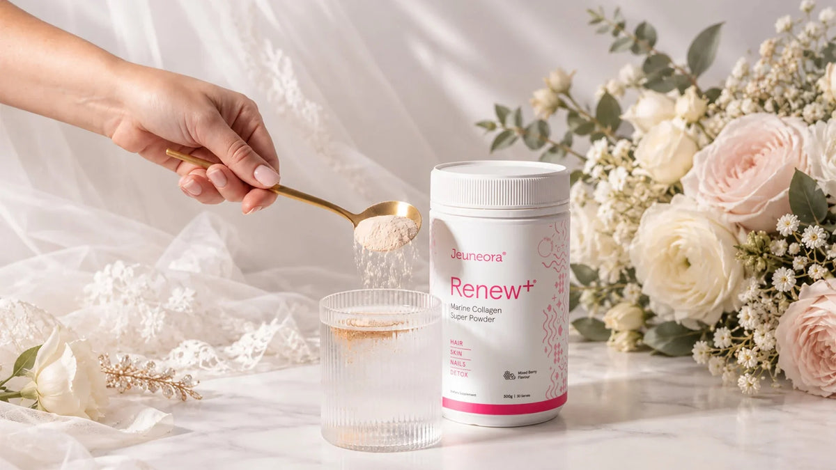 Hand spooning Renew+ marine collagen powder into a glass of water beside a bridal bouquet and lace veil