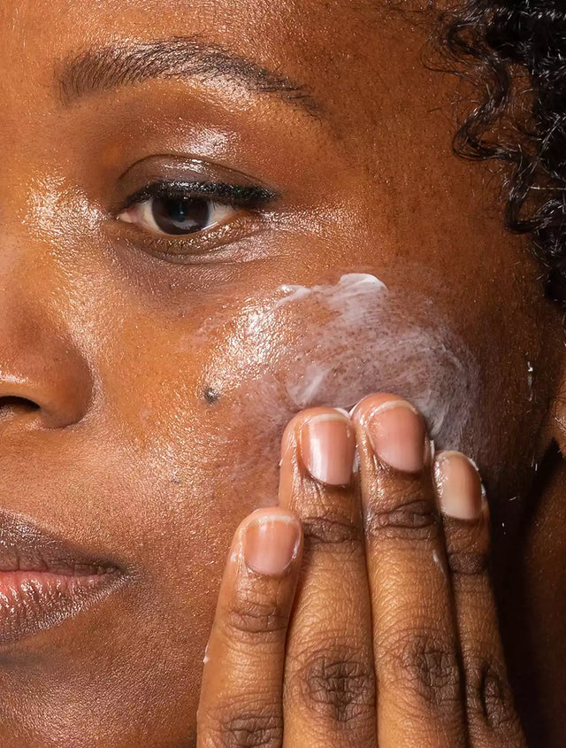 Women applying night cream to her face
