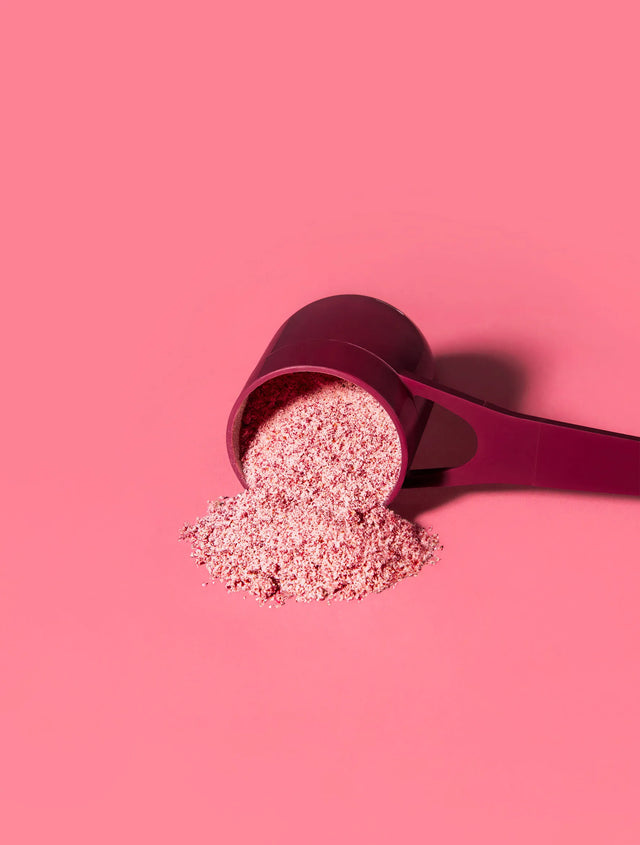 Scoop of Beauty Brain® Super Powder on pink background