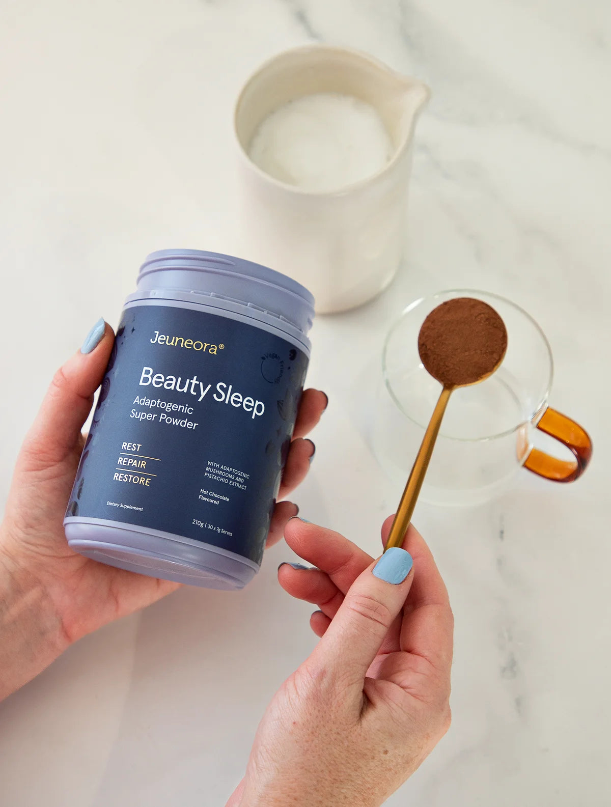 Evening routine set up making Beauty Sleep Adaptogenic hot-chocolate powder with milk jug and cup.