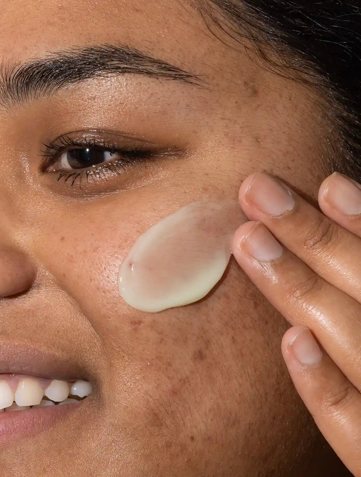 Woman applying skincare to her skin - Hydrating Serum