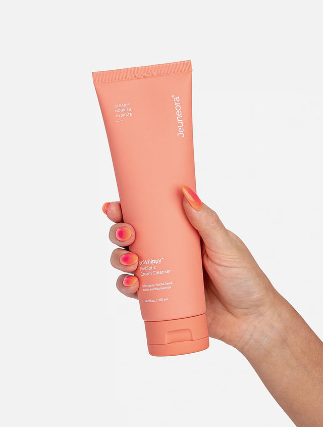 Hand holding SoWhippy™ Prebiotic Cream Cleanser